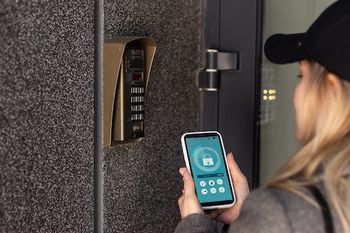 woman locking smartlock using smart phone