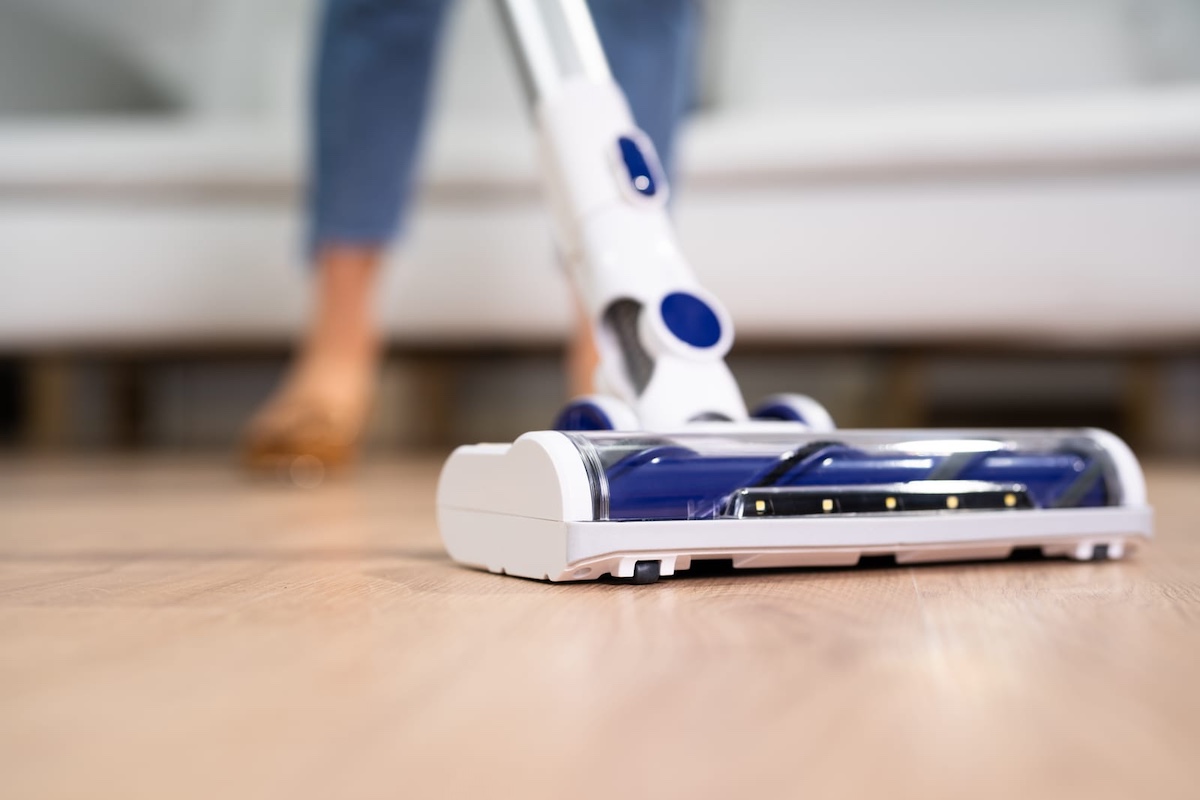 young maid cleaning floor