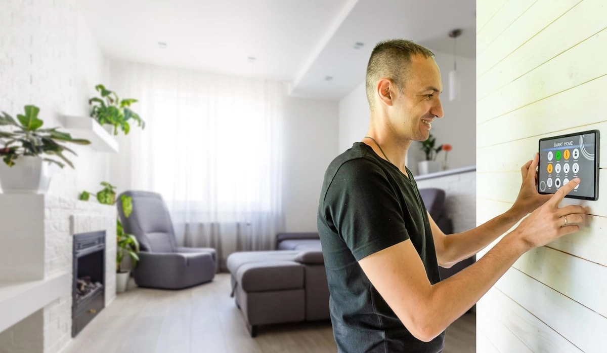 smart home control application man controls household appliances through a smartphone inside house