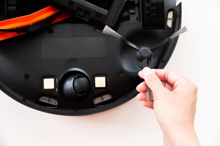 smart robot vacuum maintenance womens hands maintain and clean a round robot vacuum cleaner