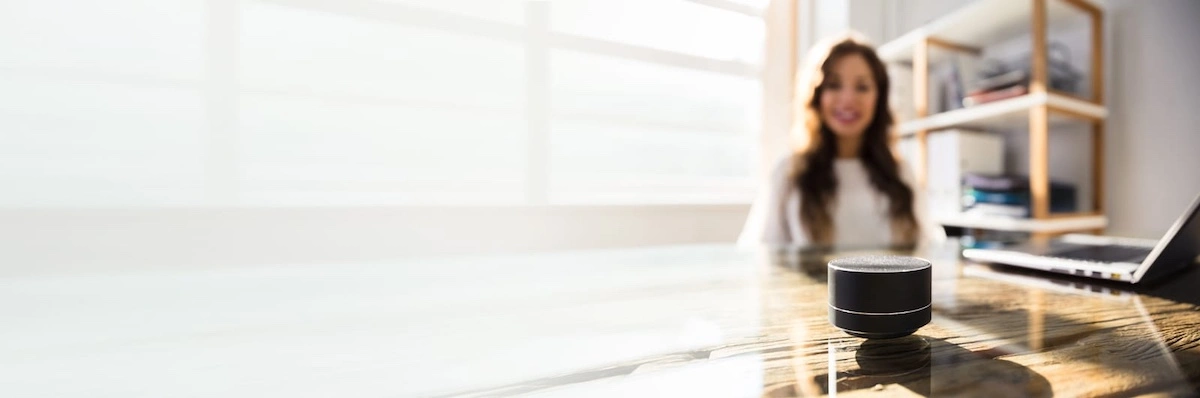 woman listening to music on wireless speaker